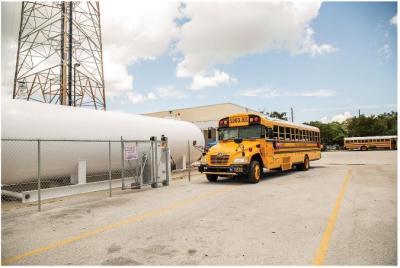 school bus next to a propane tank